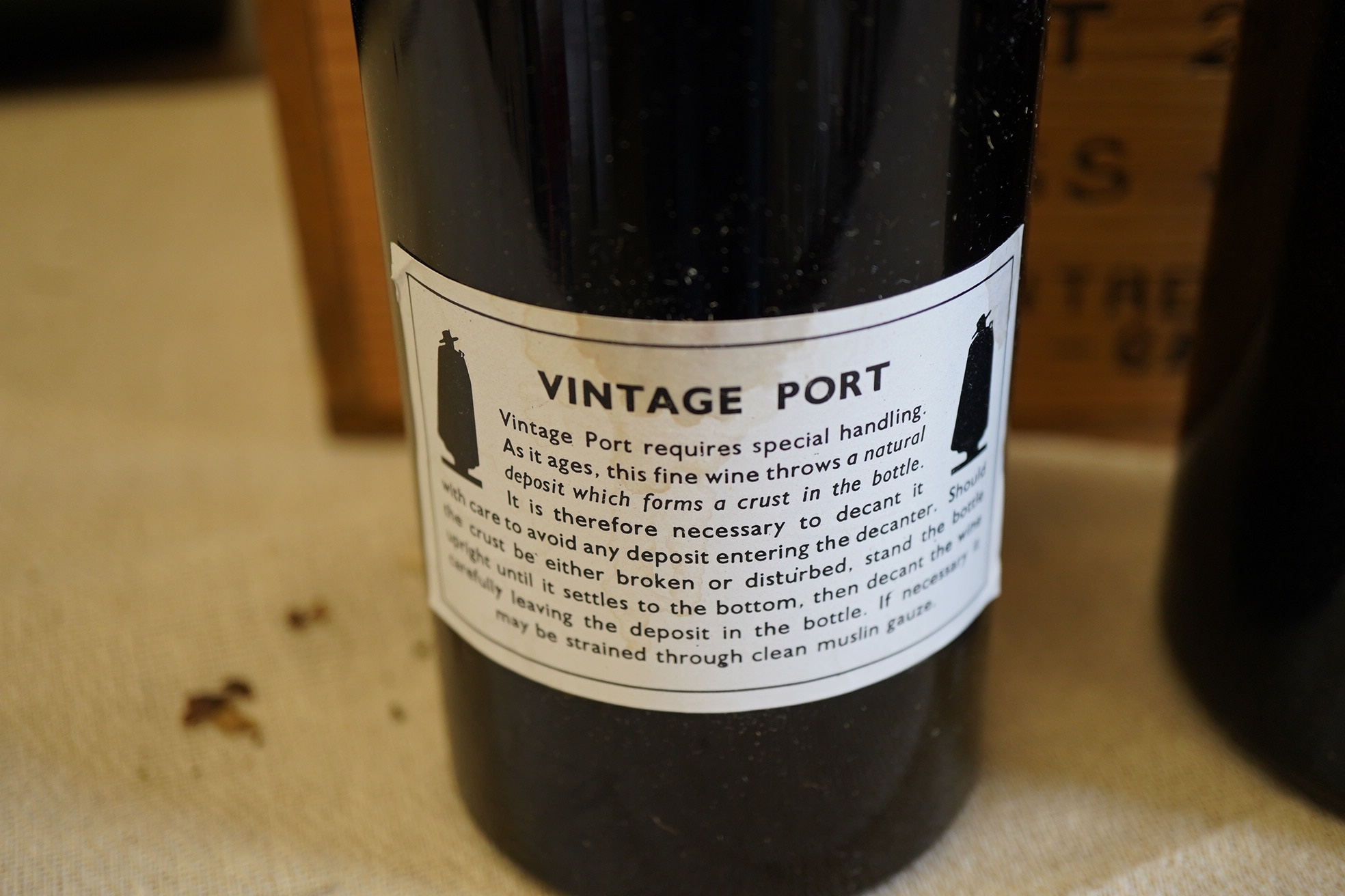 Twelve bottles of 1977 Sandeman vintage port (O.W.C but opened), and a cased bottle of 1978 Dom Perignon champagne